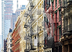 Old historic buildings in SoHo contrast against a modern tower in New York City