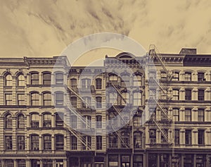 Old historic buildings in the SoHo neighborhood of New York City with faded sepia color effect