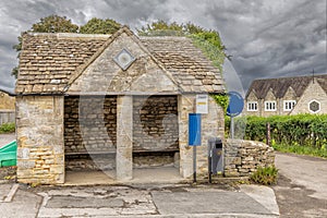 Old historic bus shelter in Nympsfield, Cotswolds, Gloucestershire, UK