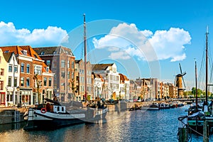 Old historic district Delfshaven with wildmill and houseboats in Rotterdam, South Holland, The Netherlands. Summer sunny day