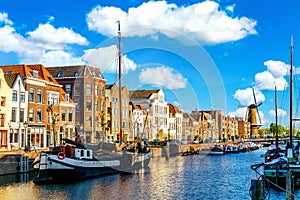 Old historic district Delfshaven with wildmill and houseboats in Rotterdam, South Holland, The Netherlands. Summer sunny day