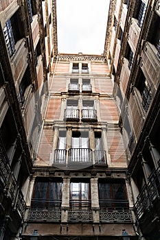 Old historic houses with windows, balconies and streetlight in Barcelona