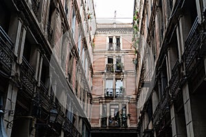 Old historic houses with windows, balconies and streetlight in Barcelona