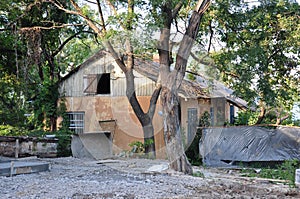 Old historic stone house on the yard with trees around. Old city buildings before and after restavration. Ancient windows, roofs, photo