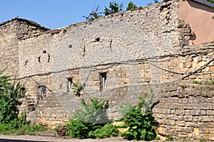 Old historic stone house on the yard with trees around. Old city buildings before and after restavration. Ancient windows, roofs, photo