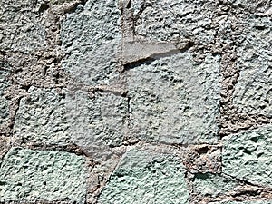 Old wall made of green cantera stone in Oaxaca, Mexico photo