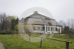 Old historic white country house surrounded by gardens on a warm autumn day