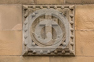 Old historical building with an anchor made of stone