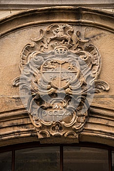Old historical building with coats of arms made of stone