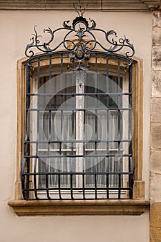 Old historical building with a lattice made of steel in front of the window