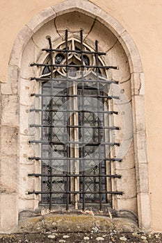 Old historical building with a lattice made of steel in front of the window