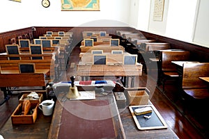 Old historical classroom with wooden desks and chalkboards