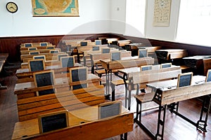 Old historical classroom with wooden desks and chalkboards