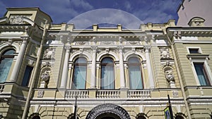 Old historical European building. Facade is yellow with white columns, exterior.