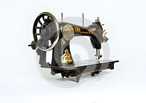 Old, historical sewing machine isolated against a white background
