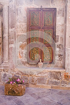 An old historical stone wall with a wooden door gate in Antalya Old town Kaleici, Turkey.