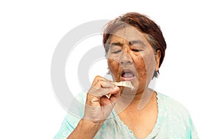 Old hoary woman open mouth and prepare to put a denture ( isolated background )