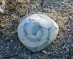 Old holey deflated soccer ball,