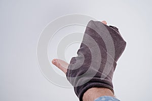 Old holey sock put on the hand