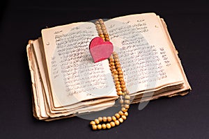 Old holy quran with heart