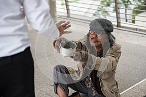 Old homeless man ask for money in city