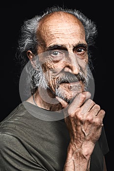 Old homeless person with a hand on chin thinking about question