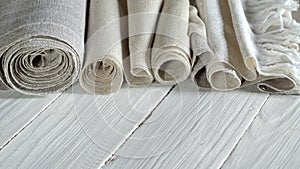 Old homespun and modern factory linen fabrics in rolls