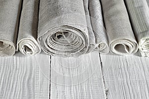 Old homespun and modern factory linen fabrics in rolls