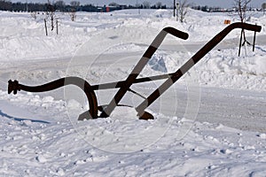 Old horse pulled plow in winter scene