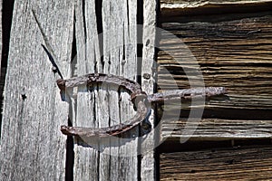 Old horseshoe used as antique barndoor hinge photo