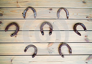 Old horseshoes fixed on a wooden wall