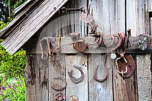 Old Horseshoes and Rusted Tools on Rustic Shack