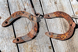 Old horseshoes on a wooden table as a vintage background.