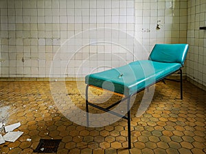 Old hospital bed standing in empty room in old hospital