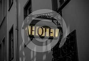 Old hotel sign made of metall on a medieval fascade photo