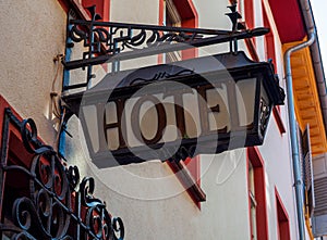 Old hotel sign made of metall on a medieval fascade