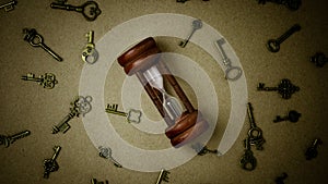 Old hourglass and classic keys on brown paper.