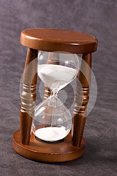Old hourglasses on a grey