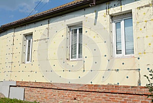 Old house brick wall renovation with facade styrofoam insulation