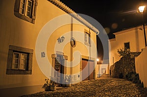 Old house in cobblestone alley at dusk in Marvao