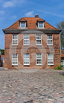 Old house at a cobblestoned street in Aurich photo