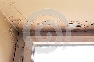 Old house with cracked wall and peeling paint