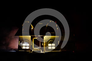 Old house with a Ghost in the moonlit night or Abandoned Haunted Horror House in fog. Old mystic villa with surreal big full moon.