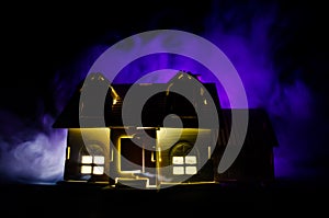 Old house with a Ghost in the moonlit night or Abandoned Haunted Horror House in fog. Old mystic villa with surreal big full moon.