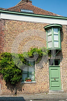 Old house with green door and windows.