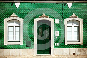 Old house with green tiles on facade