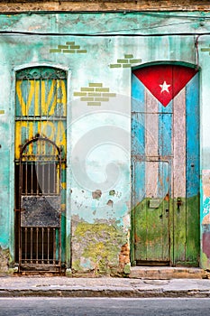 Old house in Havana with a painted cuban flag photo