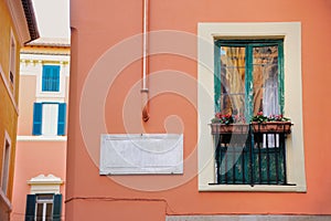 Old house in italy. Small balcony with flower pots photo for postcard