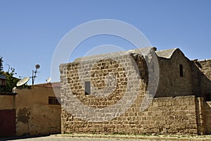 Old house with parabolic antenna close to a ruin