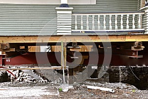 Old house resting on girders and timbers